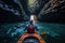 Close-up view of a girl rowing a canoe in cave in sea. Water sports. Summer tropical vacation concept.