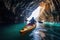 Close-up view of a girl rowing a canoe in cave in sea. Water sports. Summer tropical vacation concept.