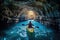 Close-up view of a girl rowing a canoe in cave in sea. Water sports. Summer tropical vacation concept.
