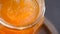 Close up view on a glass jar with fluid honey