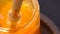 Close up view on a glass jar with smooth honey, video clip