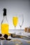 close up view of glassware with yellow champagne and wrapped gift