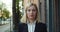 Close up view of gloomy woman in 30s raising head and looking to camera. Portrait of beautiful office worker in suit