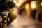 Close-up view of golden ball as decoration hanging on the branches of a Christmas tree and sparkling in the sunshine.