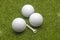 Close up view golf balls and tee on grass background