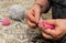 Close-up view of grandma`s hands holding knitting needles while sitting on the sofa, creating something with her own