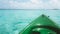 Close up view of green canoe nose surrounded by clystal clear tortoise water. Sunny day at Maldives tropical island. Isolated