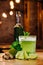 close-up view of green van gogh cocktail in glass with bottle of absinthe