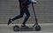 Close up view of guy in casual clothes that riding electric schooter outdoors at sunny daytime