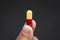 close up view of a hand holding a white Pharmaceutical medicine pill