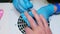 Close up view of hand during procedure of manicure. Manicurist pushes back cuticles on man\'s hand. Close up view