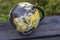 Close up view of hand turning around colorful school globe.