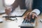 Close up view of hands of businessman use calculator calculate financial of business