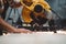 Close-up view hands of mechanic angular grinding machine in action, sparks fly apart