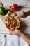 Close up view of hands serving saute vegetables