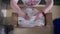 Close up view of the hands of a woman worker packed products in cardboard boxes commercial distribution factory