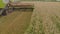 A close-up view of a harvester cutting wheat in a field.