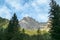 A close up view on the high and sharp peaks in Italian Dolomites. There is a narrow sunbeam in the middle of the mountain wall