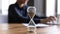 Close up view of hourglass measuring time on wooden table