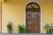 Close up view of house facade , close wooden door and potted plants