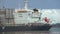 Close up view of a huge cargo vessel docked at the seaport at day.