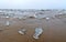 Close-up view of ice floes lying on a sandy beach during the beginning of ice drift on the Volga River.