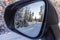 Close up view inside mirror on beautiful winter landscape. Transportation concept.