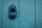 Close up view of iron doorbell on the wooden blue door.