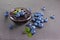 Close up view jam in glass bowl with fresh ripe blueberry and leaves