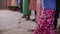 Close-up view of jumping children legs, feet. African boys and girls dancing.