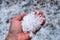 Close up view at left palm full with hailstones. Hand is freezing from cold ice and become wet and red from melting hail balls