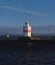 Close-up view of a lighthouse on a large Swedish lake against a blue sky