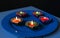 A close-up view of lit diyas arranged on plate