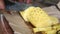 Close up view of a local man cutting pineapple, a very popular fruit which grows all around Sri Lanka.