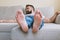 Close up view of male bare feet on sofa