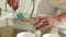 Close up view of male cook fills out bakeware for baking chocolate pie, dessert