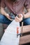 Close-up view of male hands holding power sander and sanding paper