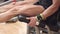 Close-up view of the man athlete with muscular legs working out at the gym leg curl trainer.