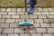 Close up view of man cleaning paving slabs.