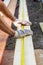 Close up view of a man hands measuring wooden plank with a tape line