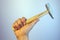 Close-up view of a man`s hand holding hammer, on white background. Repairing and maintenance. Building and destroying.