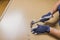 Close up view of man`s hands with hammer finishing assembling new furniture.