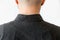 Close up view of man& x27;s shoulders in black shirt covered with dandruff. Back view. Copy space. The concept of