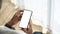 Close up view of man sitting near window and holding mock up smart phone with white screen.