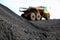 Close up view of Manganese ore with Mining Dump Truck in the background