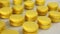Close-up view of many rows of yellow lemon macarons macaroon on white background. Classical French dessert.
