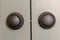 Close up view of matte black round door knobs of a gray bedroom double door