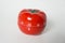 Close up view of mechanical tomato shaped kitchen clock timer for cooking and studying. Also used for pomodoro technique for time