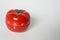 Close up view of mechanical tomato shaped kitchen clock timer for cooking and studying. Used for pomodoro technique for time and