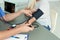 Close up view of medical assistant measuring female patient blood pressure